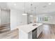 Open concept kitchen with island and views into the living area at 38 W Harding St # B, Orlando, FL 32806