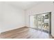 Bright bedroom with wood-look floors and sliding glass doors at 38 W Harding St # B, Orlando, FL 32806