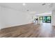 Open concept living area with hardwood floors and kitchen access at 38 W Harding St # B, Orlando, FL 32806