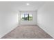 Spacious bedroom with neutral carpeting and large window at 38 W Harding St # B, Orlando, FL 32806