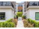 Attractive entrance to Sodo House townhomes with landscaping and walkway at 38 W Harding St # B, Orlando, FL 32806
