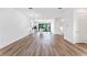 Open living space with hardwood floors and kitchen view at 38 W Harding St # B, Orlando, FL 32806
