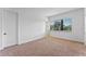 Bright bedroom with neutral carpeting and large window at 42 W Harding St # B, Orlando, FL 32806