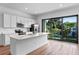 Modern kitchen with island and sliding glass doors to balcony at 42 W Harding St # B, Orlando, FL 32806