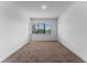 Spacious bedroom with neutral carpeting and large window at 42 W Harding St # B, Orlando, FL 32806