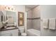 Clean bathroom with single vanity, tub shower combo, and neutral tile at Unknown Arthur Ave, Edgewater, FL 32141