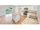 Modern kitchen with island, stainless steel appliances, and granite countertops at 888 Old Winter Haven Rd, Auburndale, FL 33823