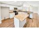 Modern kitchen with island, white cabinets, and granite countertops at 888 Old Winter Haven Rd, Auburndale, FL 33823