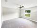 Bright bedroom with neutral walls, grey carpet, and a ceiling fan at 888 Old Winter Haven Rd, Auburndale, FL 33823
