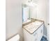 Bathroom with granite countertop, white vanity, and updated fixtures at 888 Old Winter Haven Rd, Auburndale, FL 33823