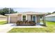Charming house exterior with gray siding, garage, and landscaping at 888 Old Winter Haven Rd, Auburndale, FL 33823