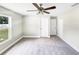 Bright bedroom with ceiling fan and plush carpeting at 888 Old Winter Haven Rd, Auburndale, FL 33823