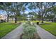 Landscaped walkway with benches and lush trees at 3383 Westchester Square Blvd # 204, Orlando, FL 32835