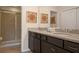 Bathroom with granite countertops, double sinks, and a shower at 8924 Adriatico Ln, Kissimmee, FL 34747