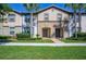 Two story townhome with gray siding and lush landscaping at 8924 Adriatico Ln, Kissimmee, FL 34747