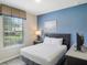 Bright bedroom with a queen bed, large window, and a TV at 8924 Adriatico Ln, Kissimmee, FL 34747