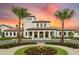 Elegant clubhouse featuring a grand entrance and landscaping at 8924 Adriatico Ln, Kissimmee, FL 34747