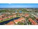 Aerial view of community, featuring a lake, pool, and numerous buildings at 5530 Metrowest Blvd # 9-211, Orlando, FL 32811