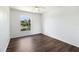 Spacious bedroom with wood-look floors and a large window at 5530 Metrowest Blvd # 9-211, Orlando, FL 32811