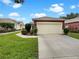 Single-story home with attached garage and well-maintained lawn at 9597 Sw 70Th Loop, Ocala, FL 34481