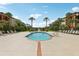 Community swimming pool with lounge chairs and palm trees at 5530 Metrowest Blvd # 9-311, Orlando, FL 32811