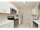 Modern kitchen with white shaker cabinets and stainless steel appliances at 6451 Old Park Ln # 110, Orlando, FL 32835