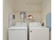 Laundry room with washer, dryer, and shelving for storage at 6451 Old Park Ln # 110, Orlando, FL 32835