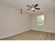 Spacious bedroom featuring hardwood floors and a large window at 6451 Old Park Ln # 110, Orlando, FL 32835