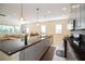 Open concept kitchen with granite countertops and stainless steel appliances at 4909 W Fountainwood Dr, St Cloud, FL 34772