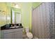 Bright bathroom with granite vanity, shower/tub combo, and gray geometric shower curtain at 4909 W Fountainwood Dr, St Cloud, FL 34772