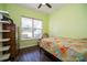Bright bedroom with a window and floral bedding at 4909 W Fountainwood Dr, St Cloud, FL 34772