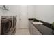Convenient laundry room with granite countertops and washer/dryer at 4909 W Fountainwood Dr, St Cloud, FL 34772