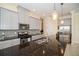 Modern kitchen featuring gray cabinets, granite countertops, and mosaic backsplash at 4909 W Fountainwood Dr, St Cloud, FL 34772