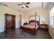 Main bedroom with a four poster bed and large wardrobe at 4909 W Fountainwood Dr, St Cloud, FL 34772