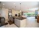 Open kitchen with island, stainless steel appliances, and granite countertops at 4909 W Fountainwood Dr, St Cloud, FL 34772