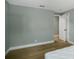Simple bedroom with hardwood floors and a view into another room at 1406 S Hoagland Blvd, Kissimmee, FL 34746
