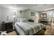 Cozy bedroom with striped bedding and a dark wood nightstand at 1406 S Hoagland Blvd, Kissimmee, FL 34746