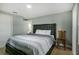 Spacious bedroom with a king-size bed and wood chair at 1406 S Hoagland Blvd, Kissimmee, FL 34746
