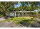 Newly renovated single story house with a white garage door and a well maintained lawn at 1406 S Hoagland Blvd, Kissimmee, FL 34746