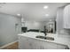 Modern kitchen with white cabinets, quartz countertops, and stainless steel sink at 1406 S Hoagland Blvd, Kissimmee, FL 34746