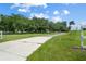 Long driveway leading to a charming house with lush green landscaping at 1406 S Hoagland Blvd, Kissimmee, FL 34746