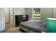 Bright bedroom with wood floors, dresser, and a window offering a view of the backyard at 1406 S Hoagland Blvd, Kissimmee, FL 34746