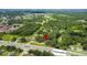Aerial view showing property location near a road and wooded area at 1406 S Hoagland Blvd, Kissimmee, FL 34746