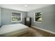 Spacious bedroom with two windows, hardwood floors, and a dresser at 1406 S Hoagland Blvd, Kissimmee, FL 34746