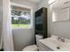Clean bathroom with shower, toilet, vanity, and a window adding natural light at 1406 S Hoagland Blvd, Kissimmee, FL 34746
