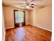 Bright bedroom with wood-look floors and large window at 125 Reserve Cir # 205, Oviedo, FL 32765