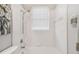 Bright bathroom with a shower/tub combo and white tile at 445 Hightower Dr, Debary, FL 32713