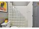 Clean bathroom with glass block shower and white toilet at 445 Hightower Dr, Debary, FL 32713
