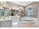 Bathroom with double sinks, corner tub, and updated fixtures at 445 Hightower Dr, Debary, FL 32713