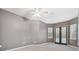 Bedroom with grey walls, carpet flooring, and pool access at 445 Hightower Dr, Debary, FL 32713